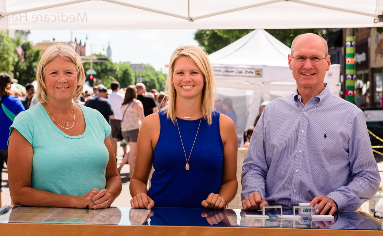 pam ulness, marit ulness and john ulness at the ulness health booth at the downtown appleton farm market